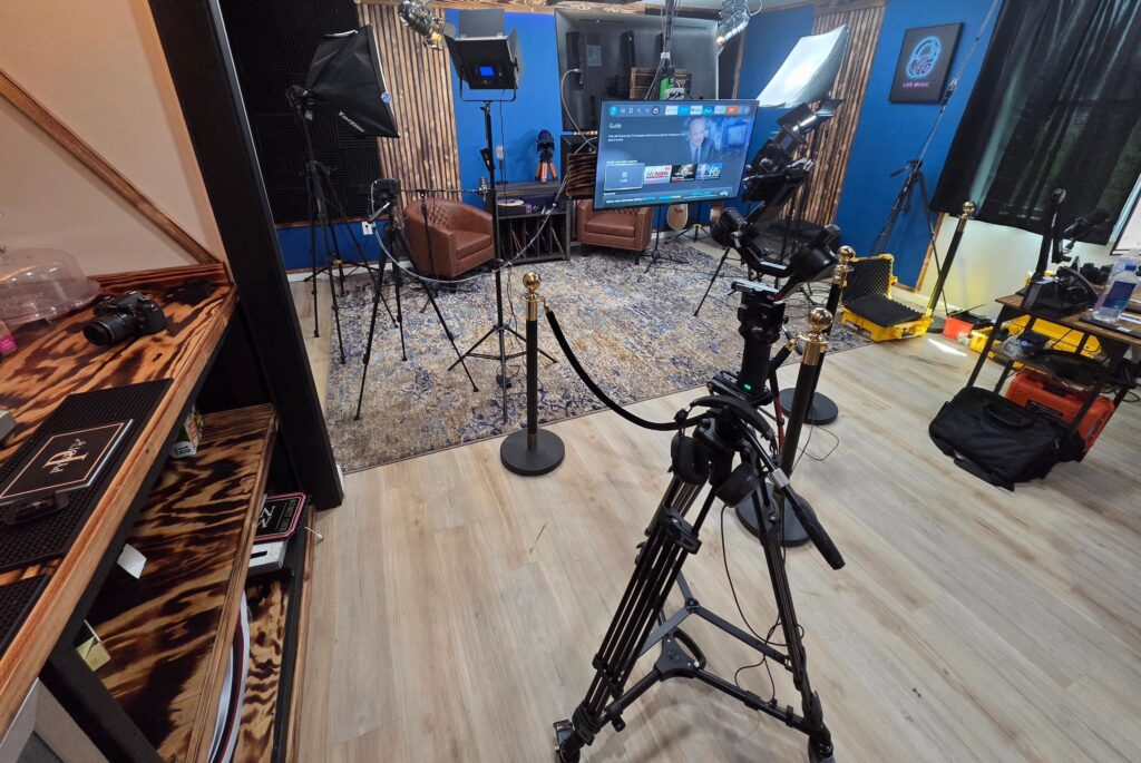 Cameras, microphones, and recording equipment arranged in a studio.