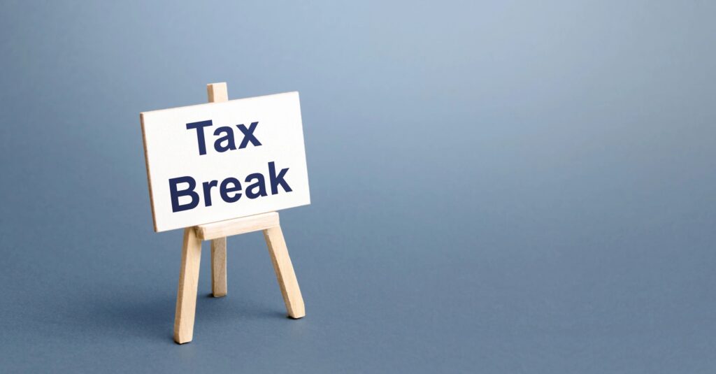 A small sign reading Tax Break on a wooden easel.