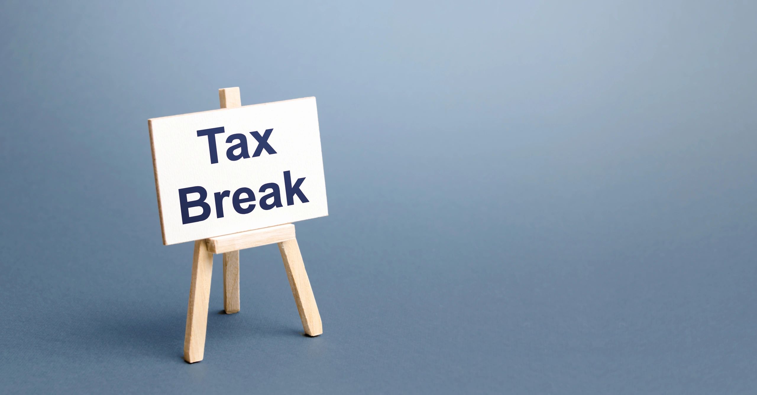 A small sign reading Tax Break on a wooden easel.