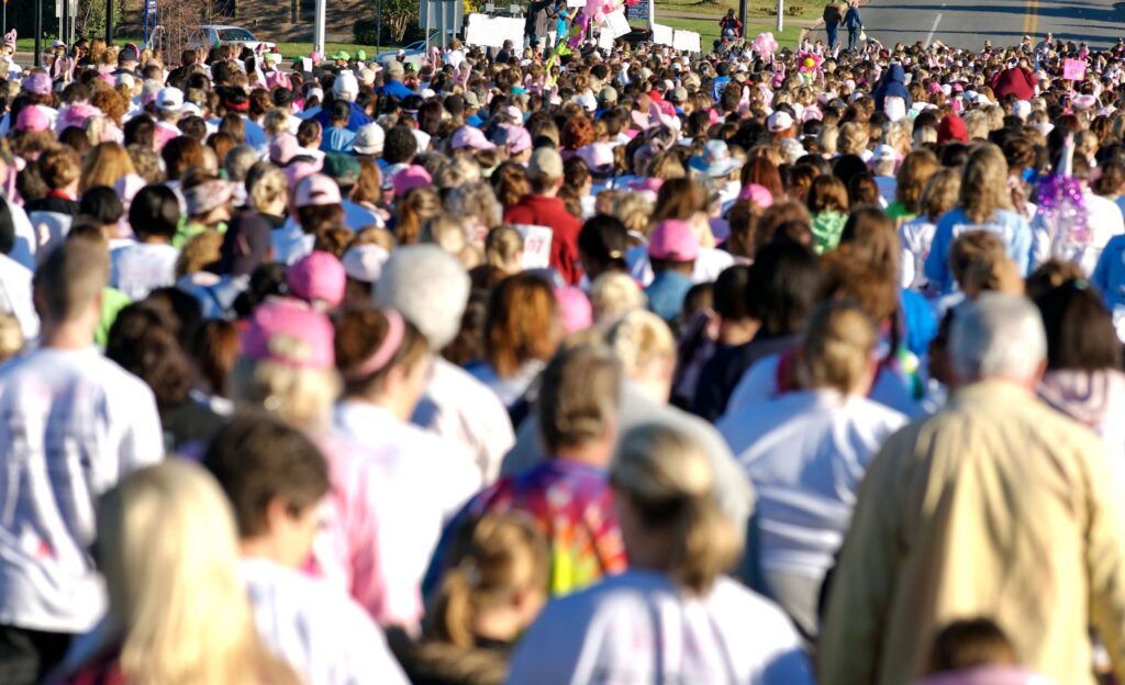 A large crowd gathered outdoors at a community event.