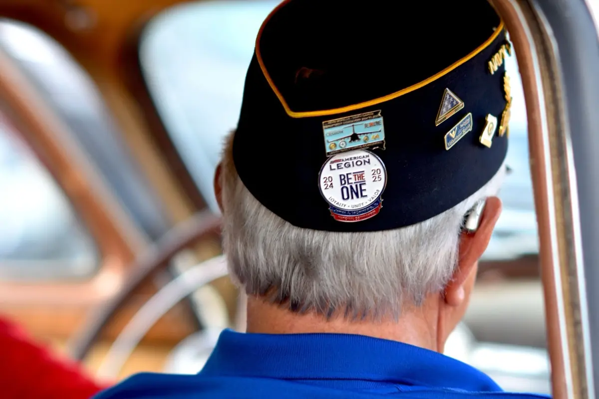 A veteran wearing an American Legion cap.