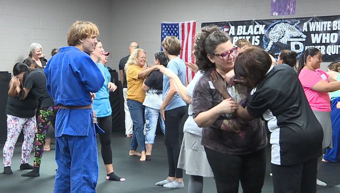 Participants practice self-defense skills with partners at Legacy Evolution Martial Arts.